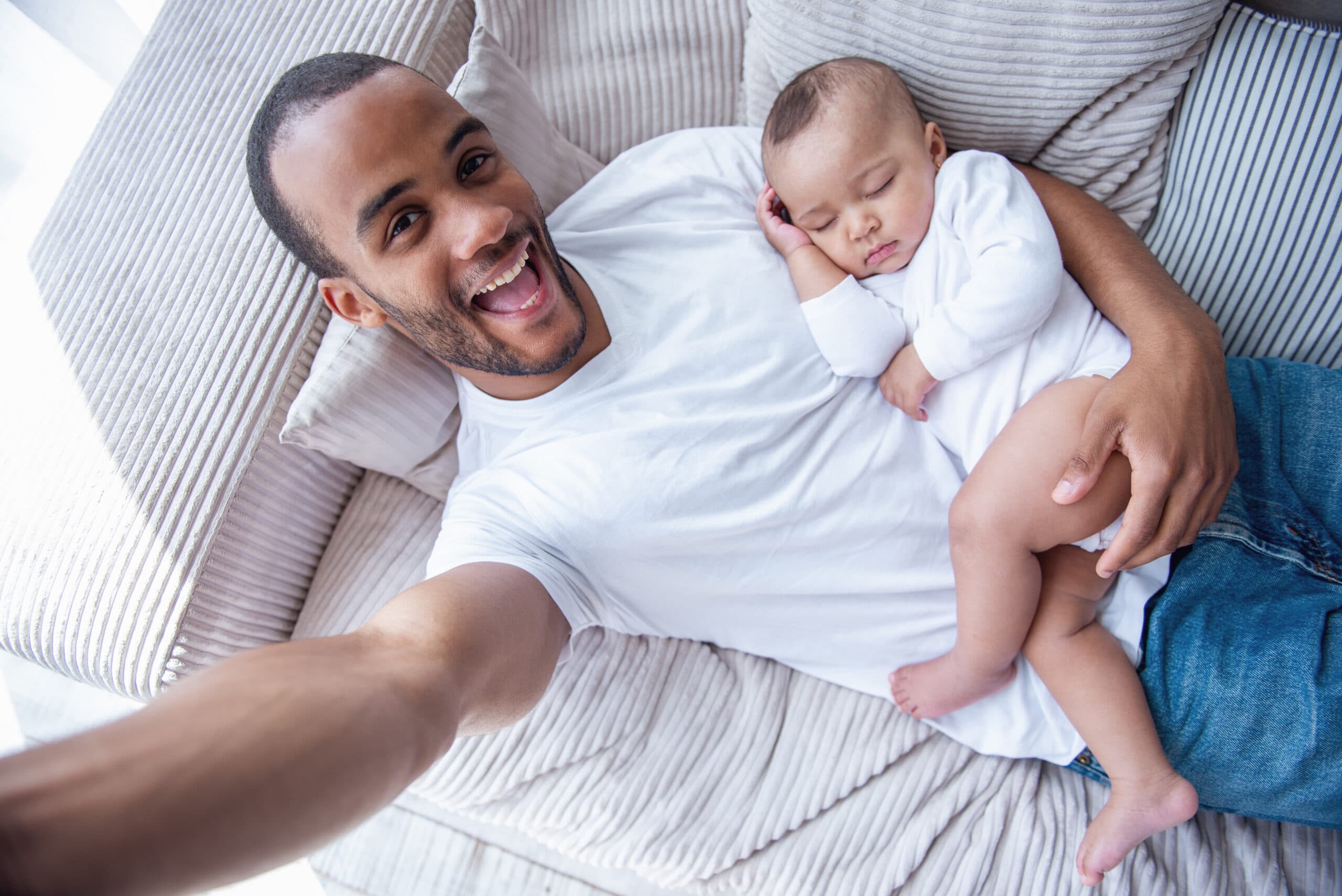 Father holding sleeping baby - paternity DNA testing